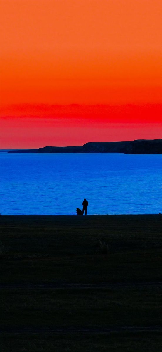 sunset over blue water
