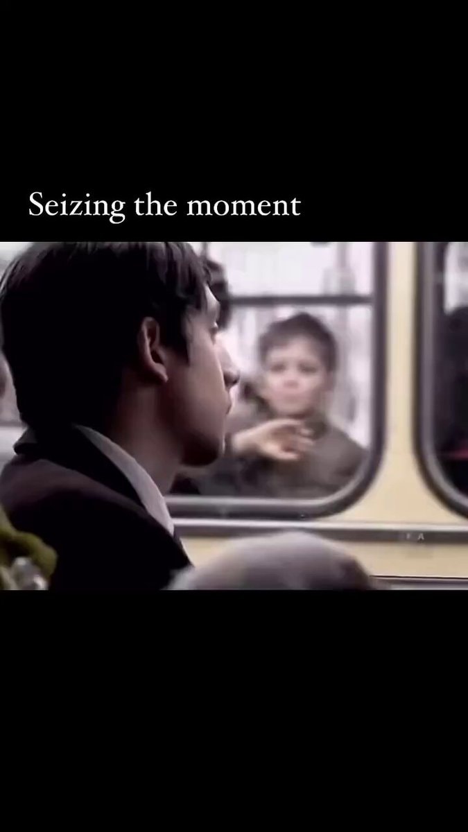 young man looking out window