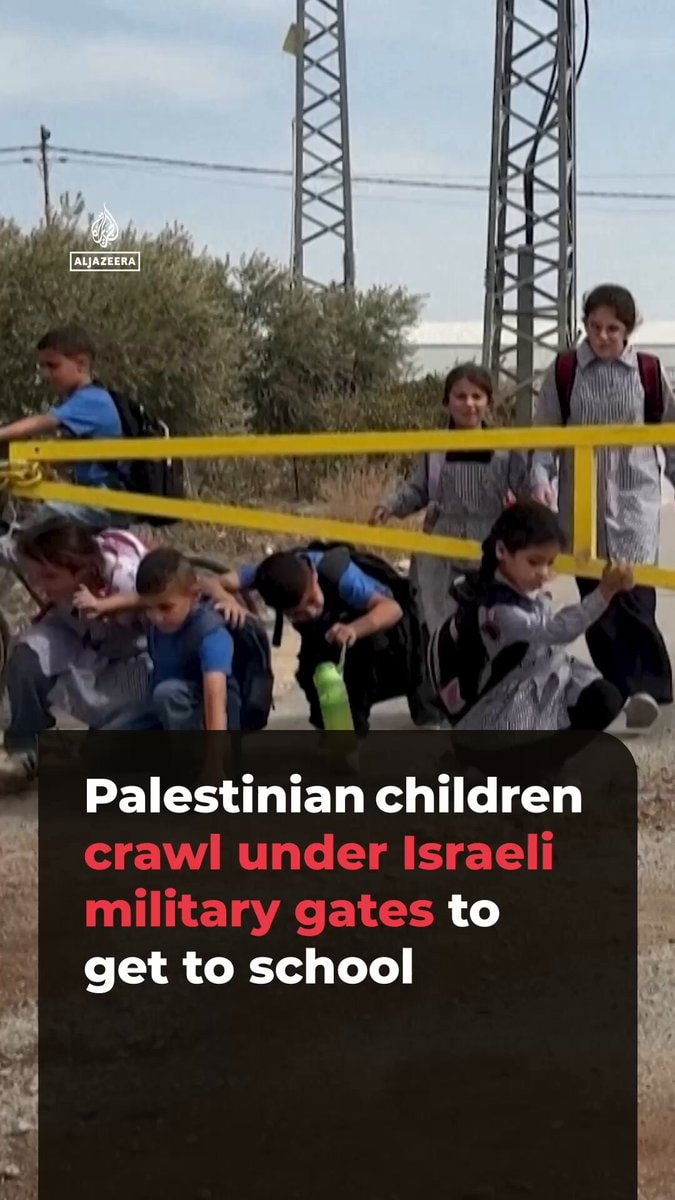 Palestinian children crawl under Israeli gates to school