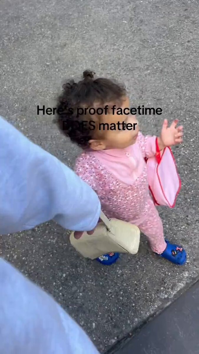 toddler walking on sidewalk