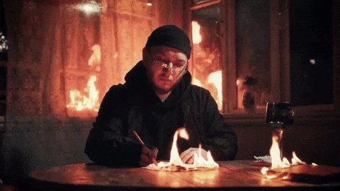 person writing on burning paper