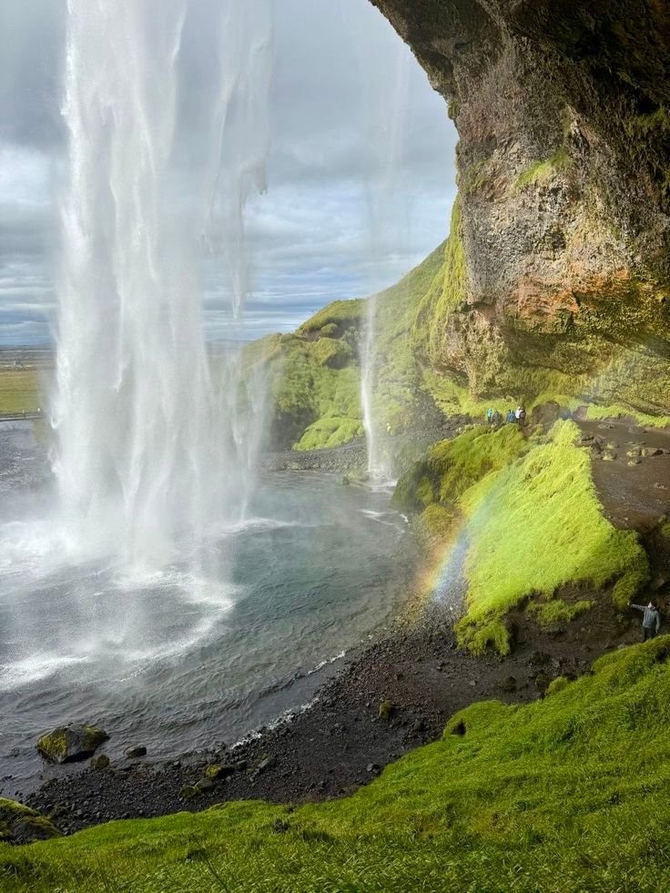 Waterfall with people and rainbow