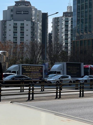 Protest trucks outside HYBE headquarters (photo 2 of 4)