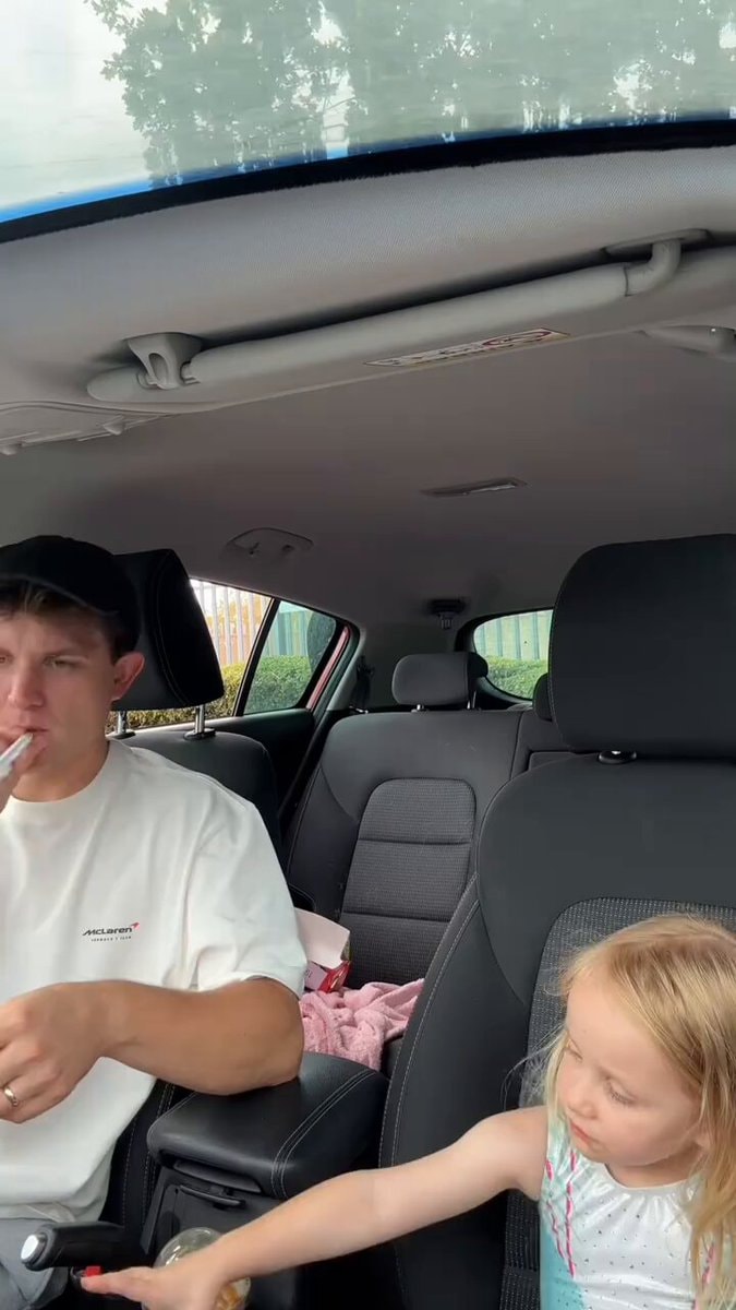 man in McLaren shirt with child