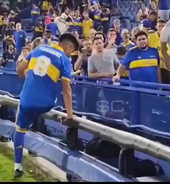 soccer player climbing barrier