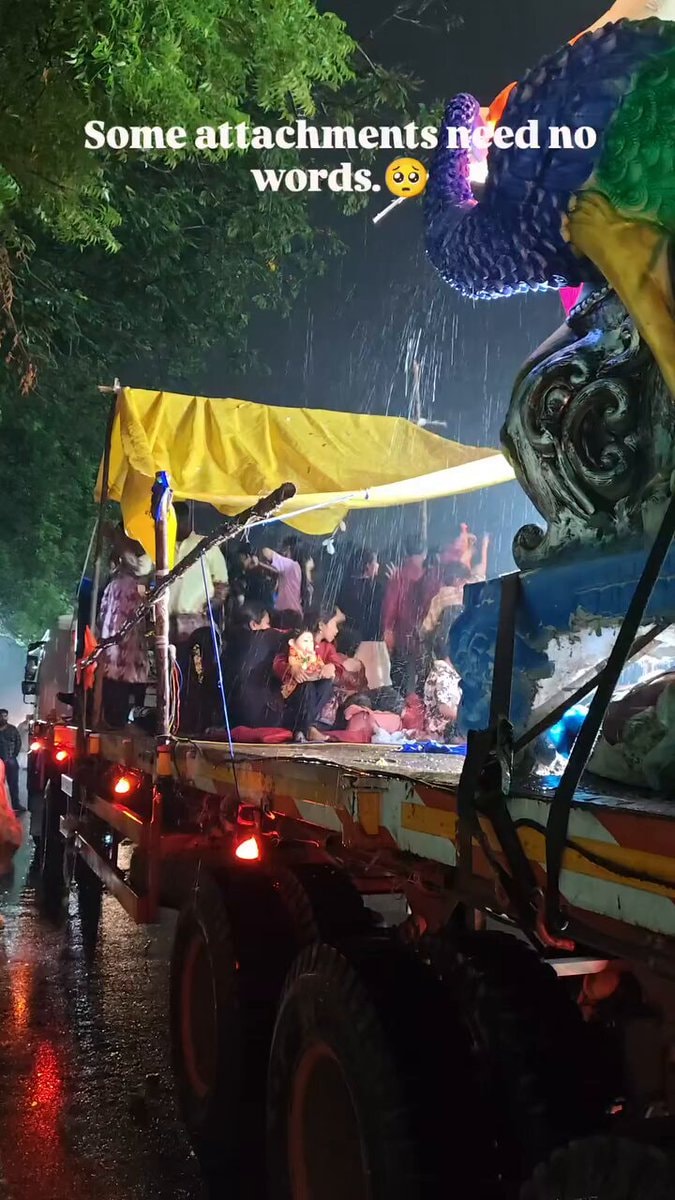 Girl holding Bappa in rain