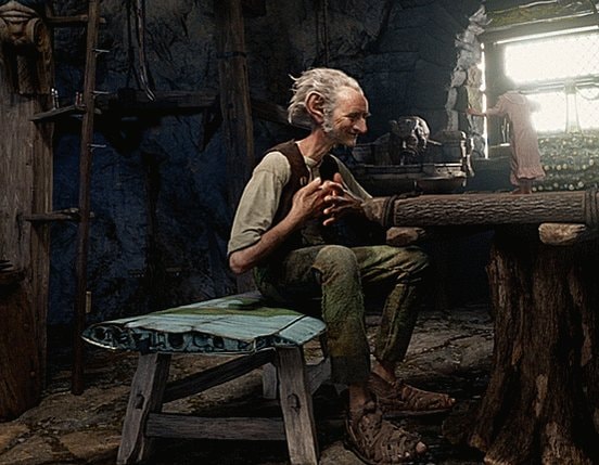 elderly man with large ears sitting indoors