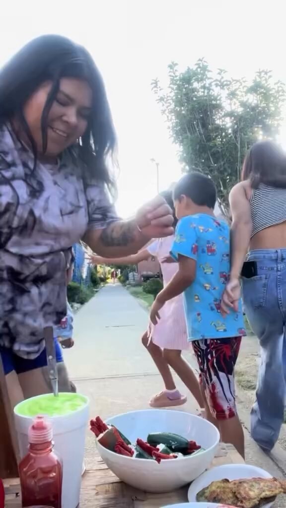 Woman shares food at outdoor gathering