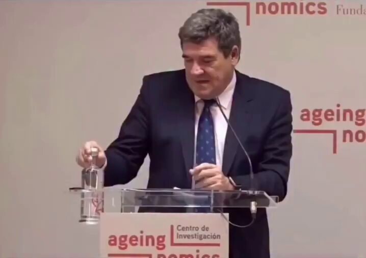 Spain's minister pours water in cup holder