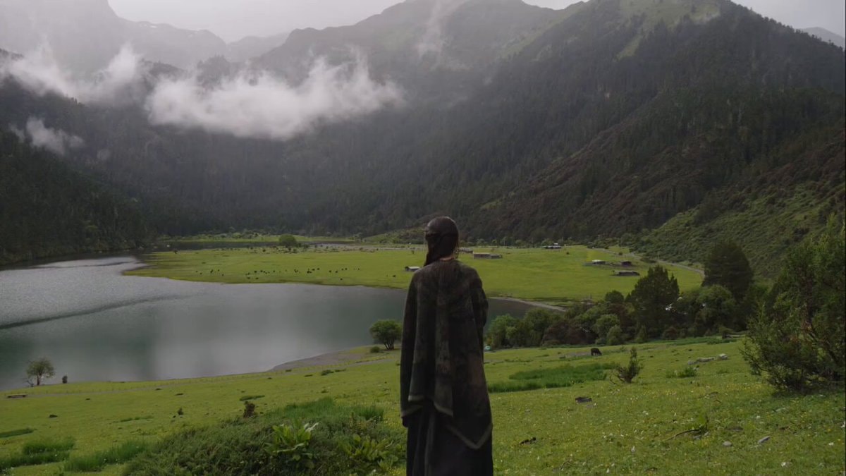 Peaceful lake view with cloak figure