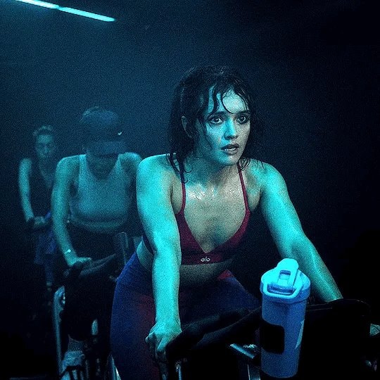 woman cycling intensely