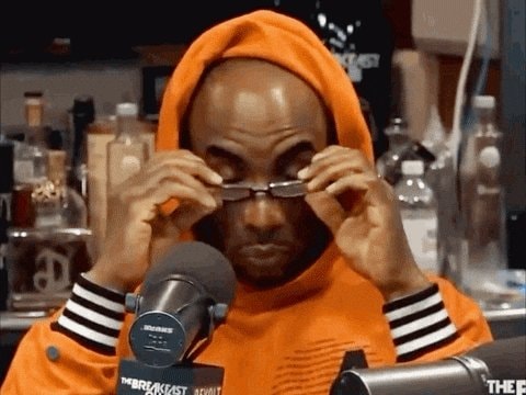 man in orange hoodie adjusting glasses