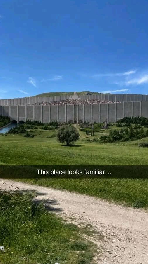 Massive wall with city beyond