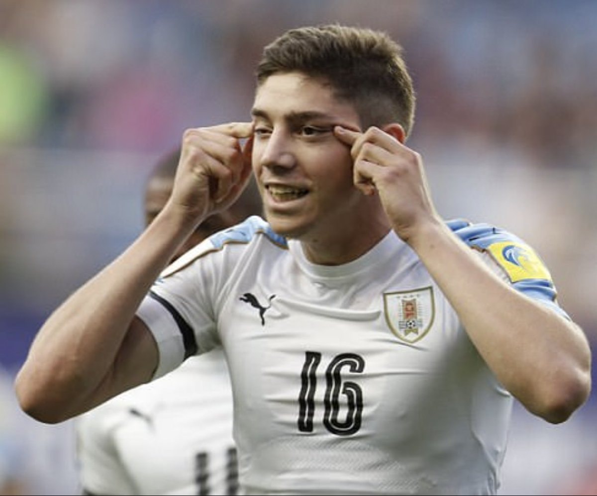 Soccer player in white and blue jersey