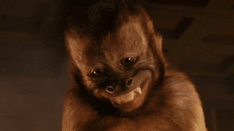 Grinning monkey with sharp teeth
