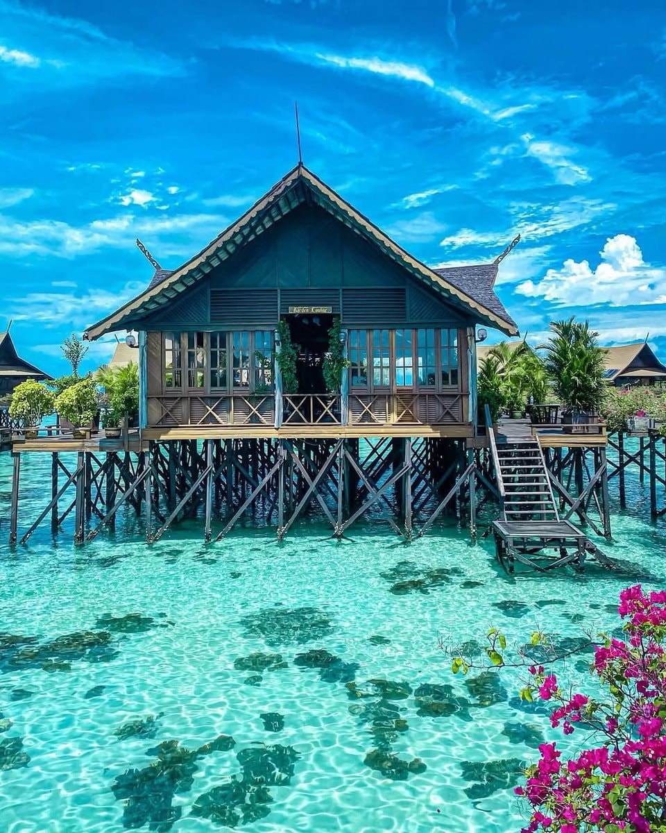 Maldives stilt house over turquoise water