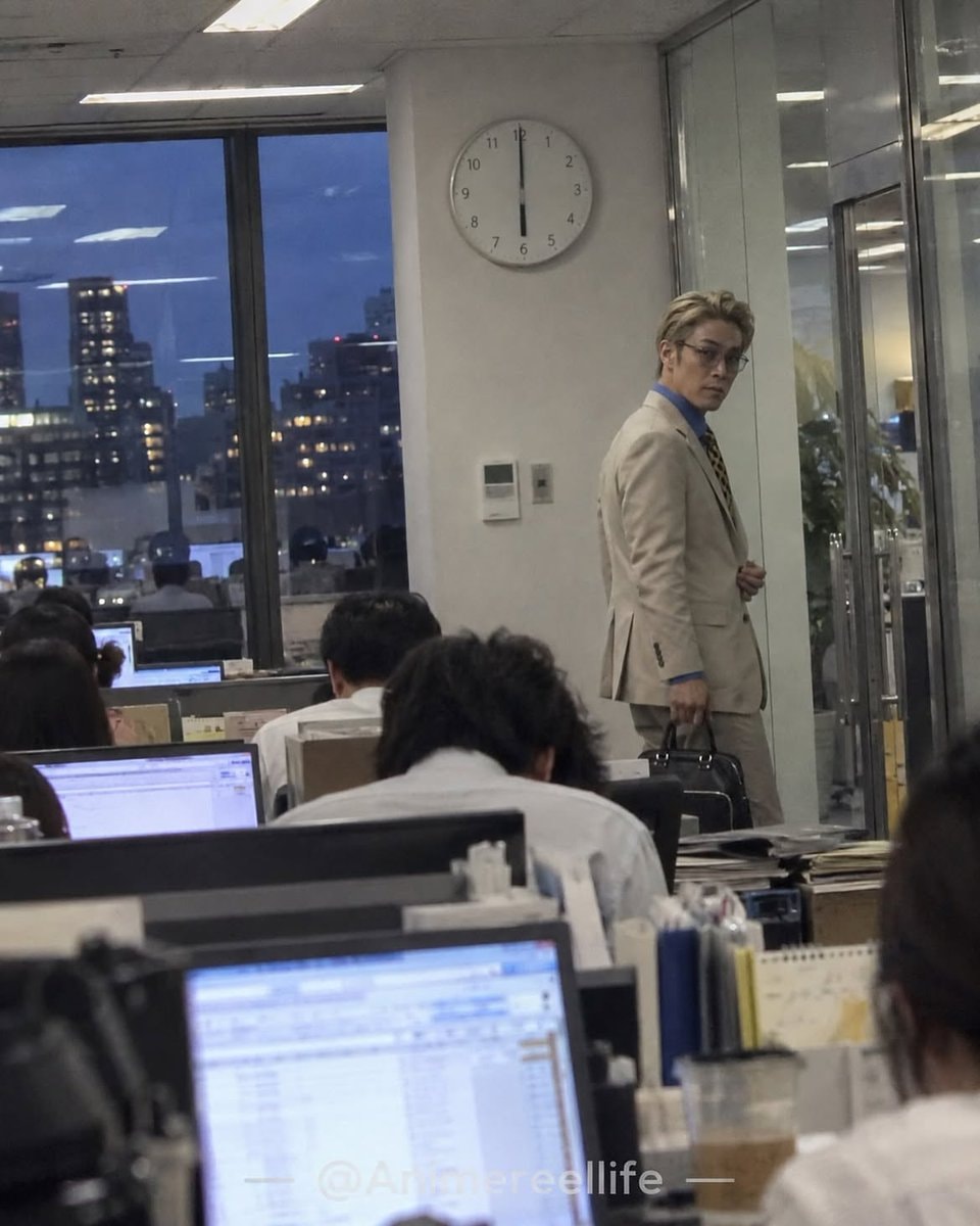 man in light suit office