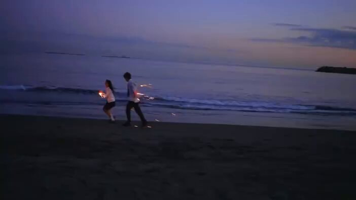 Couple sparklers beach dusk