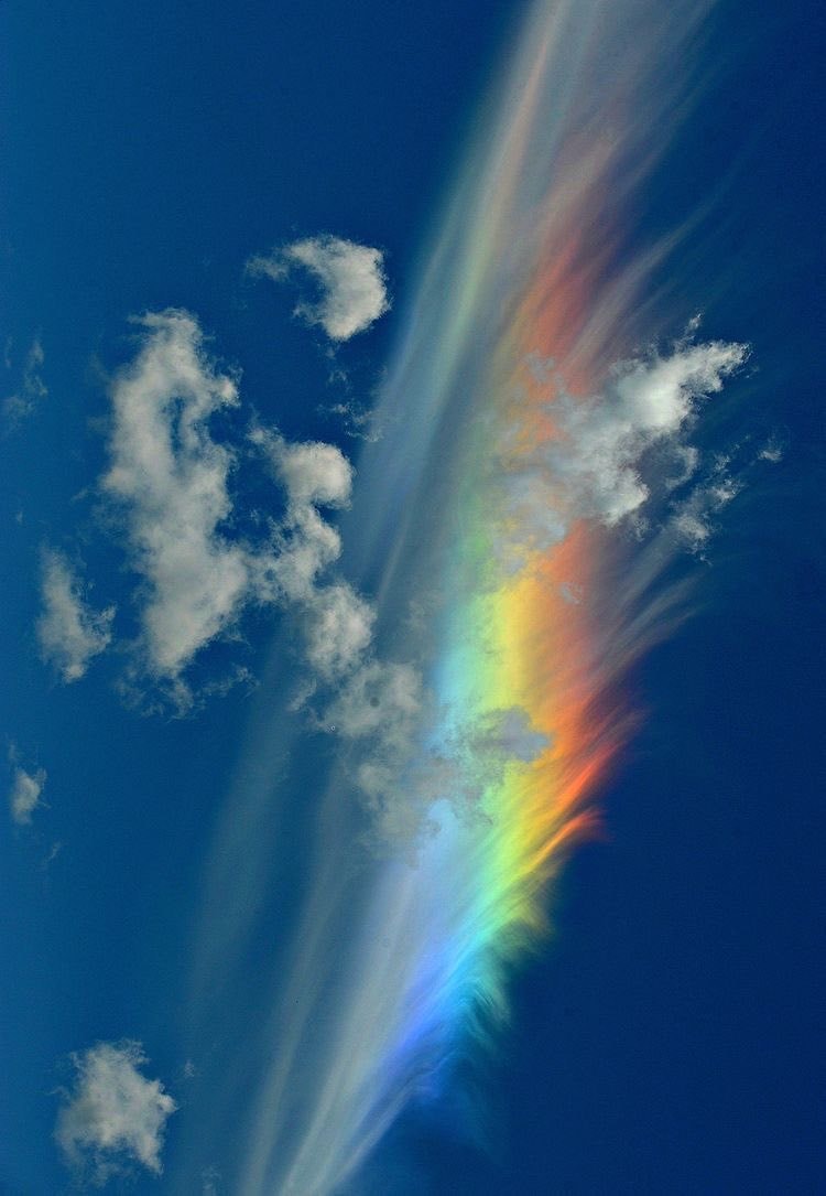 Rainbow cloud in blue sky