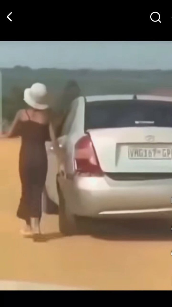 woman in black dress walking