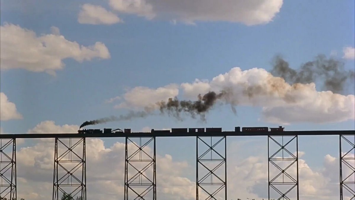 steam train crossing trestle bridge