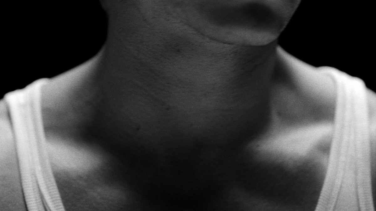 close up neck jaw white tank