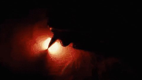 Silhouette against orange lights