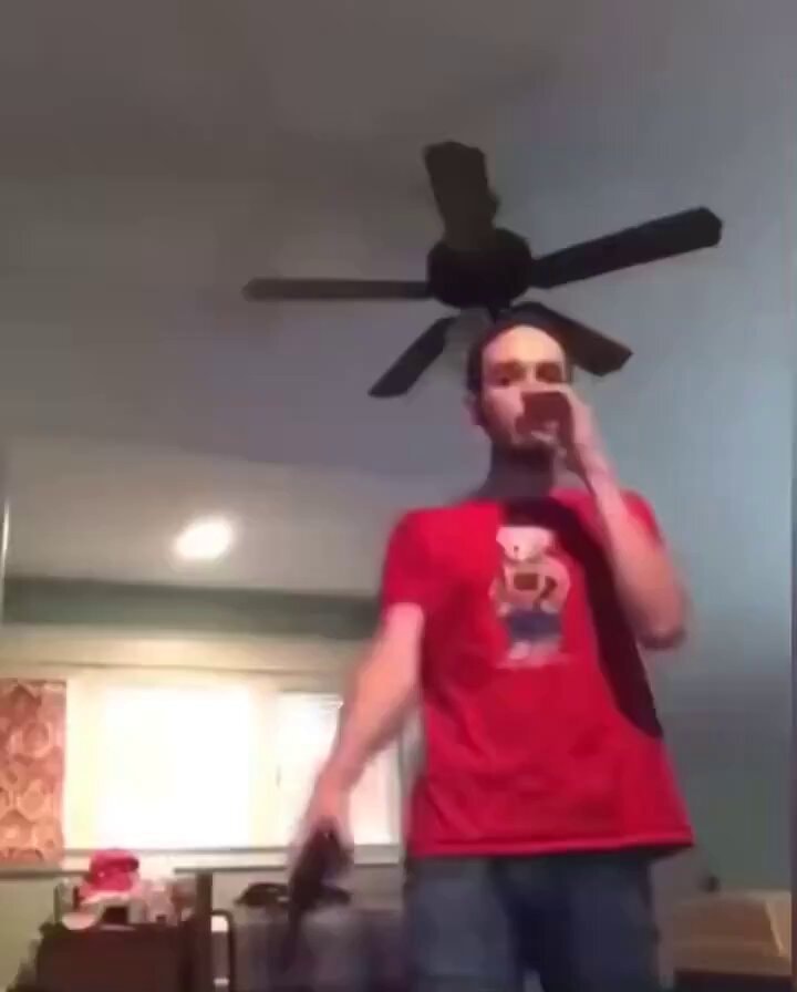 man holding phone and gun