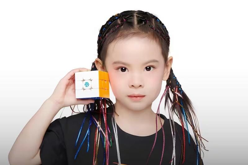 girl holding cube puzzle