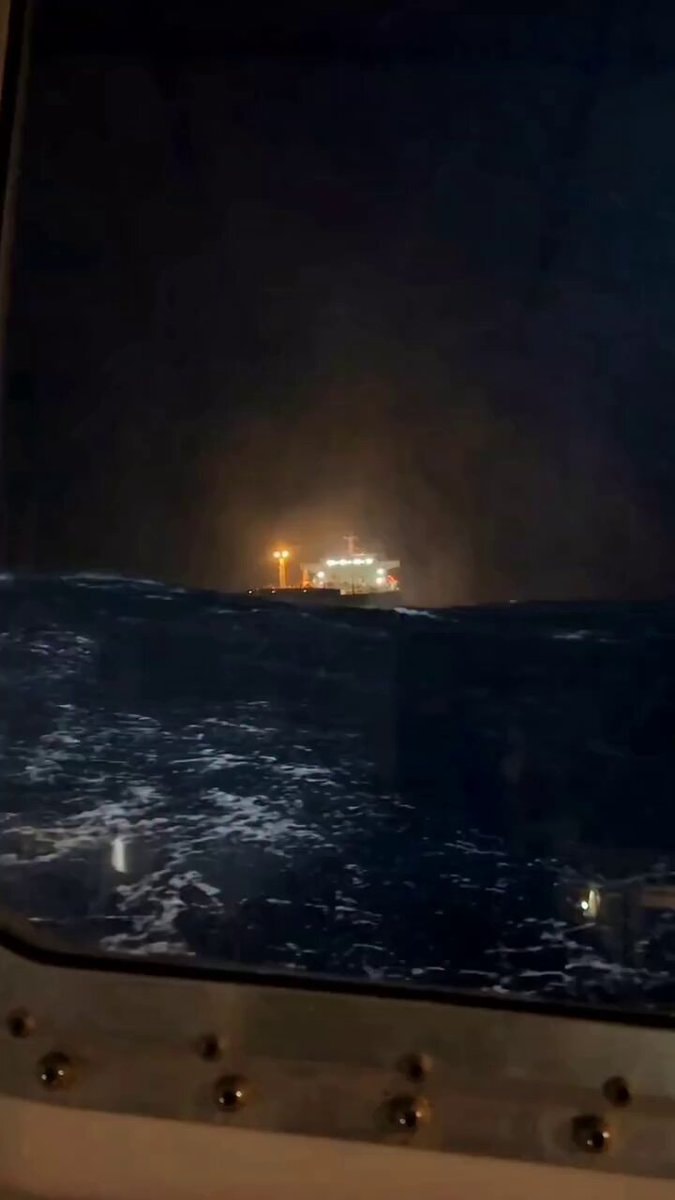 cargo ship in night storm