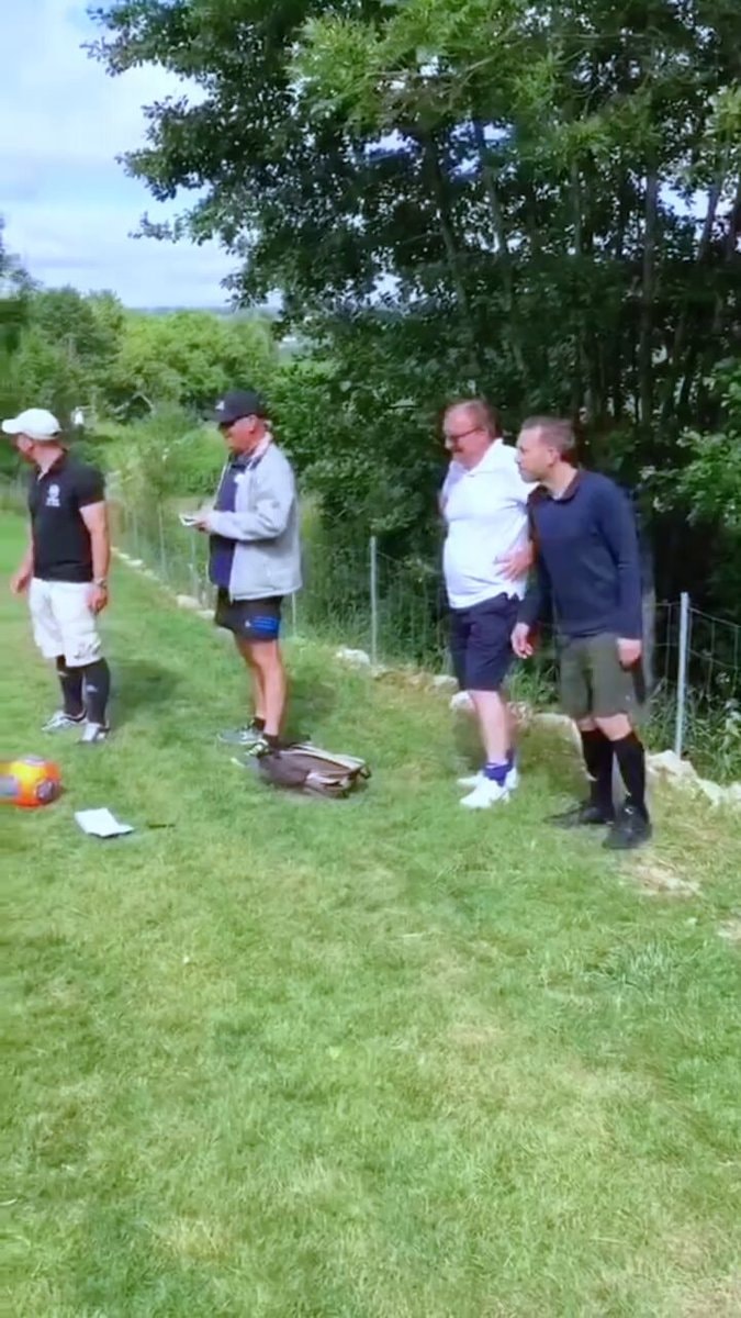 Four men playing soccer on a field