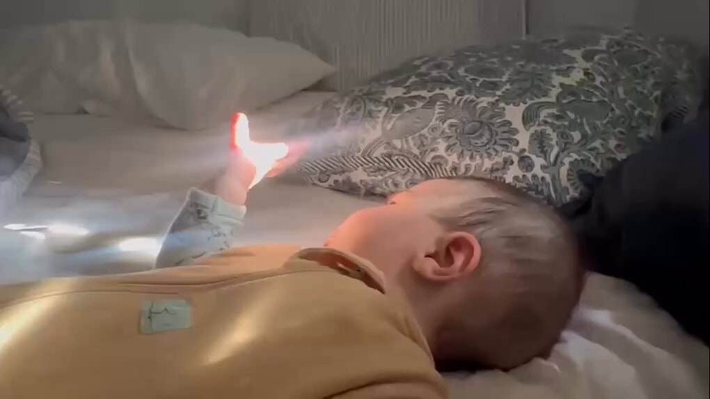 baby reaching for the light