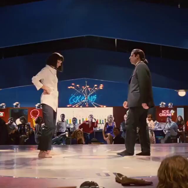Iconic dance scene with neon ice cream sign