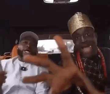 Two men in vehicle with gold crown