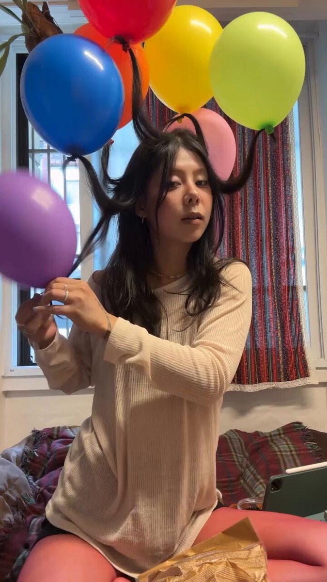 Woman celebrates birthday with balloon pigtails