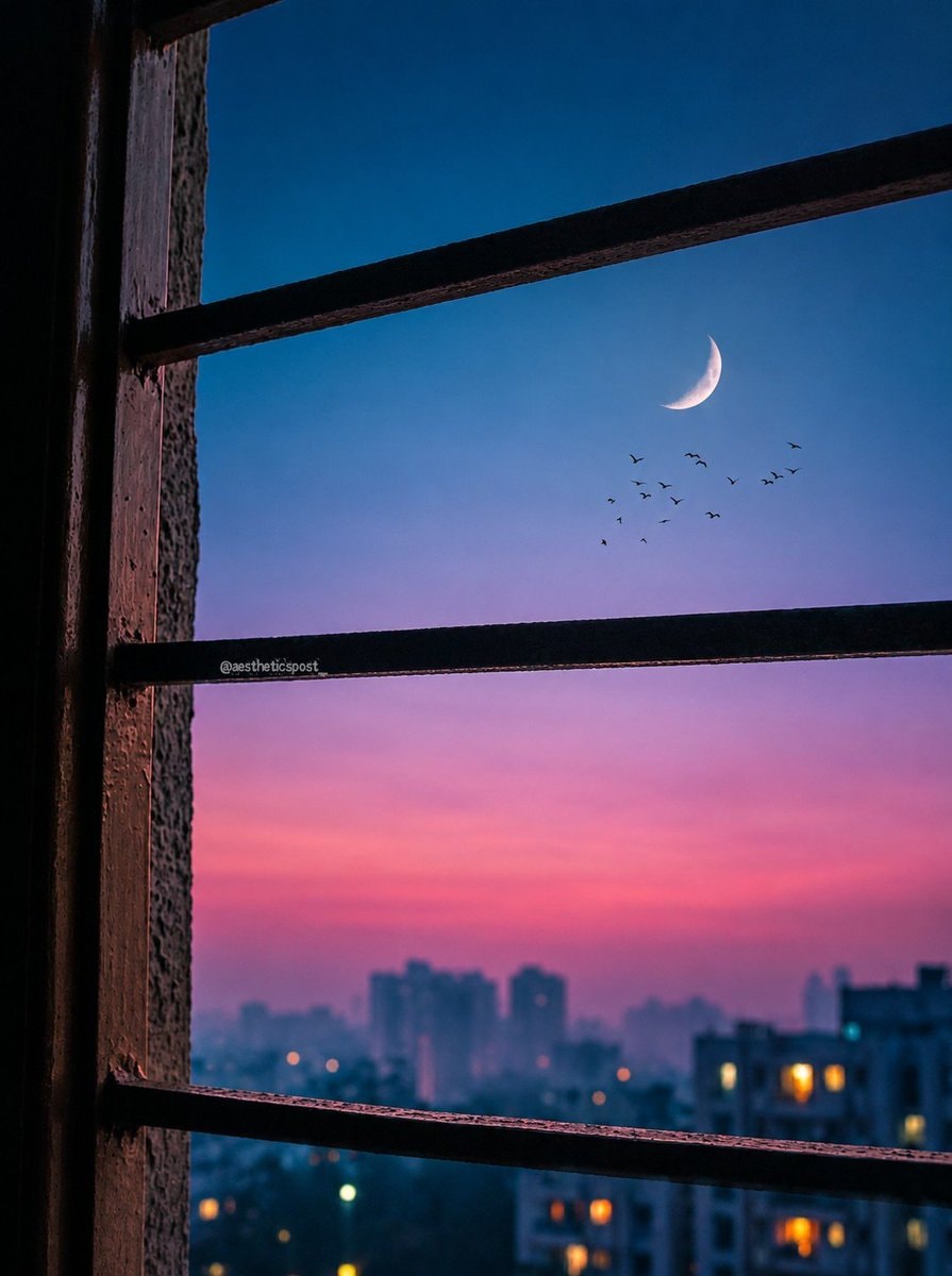 crescent moon over cityscape