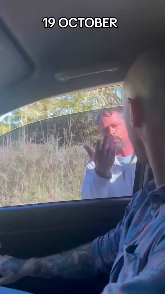 Two people talking through a car window