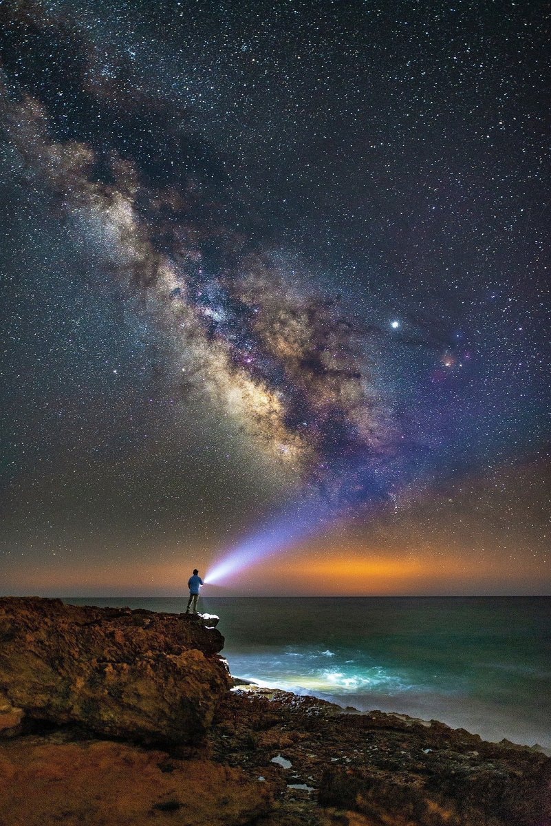 Milky Way galaxy over ocean cliff