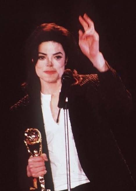 Man Holding Awards (photo 2 of 4)