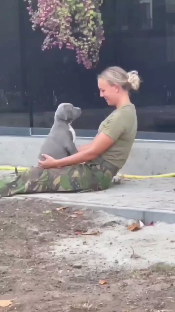 Woman and puppy smiling at each other