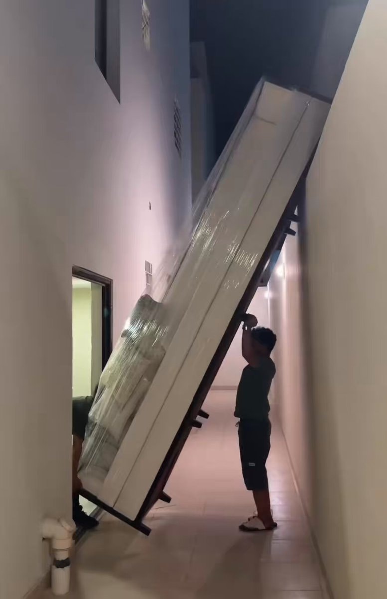 mattress struggle in narrow hallway
