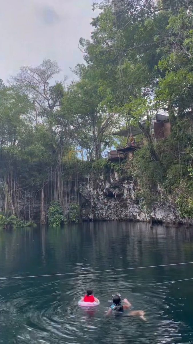 children swimming in cenote