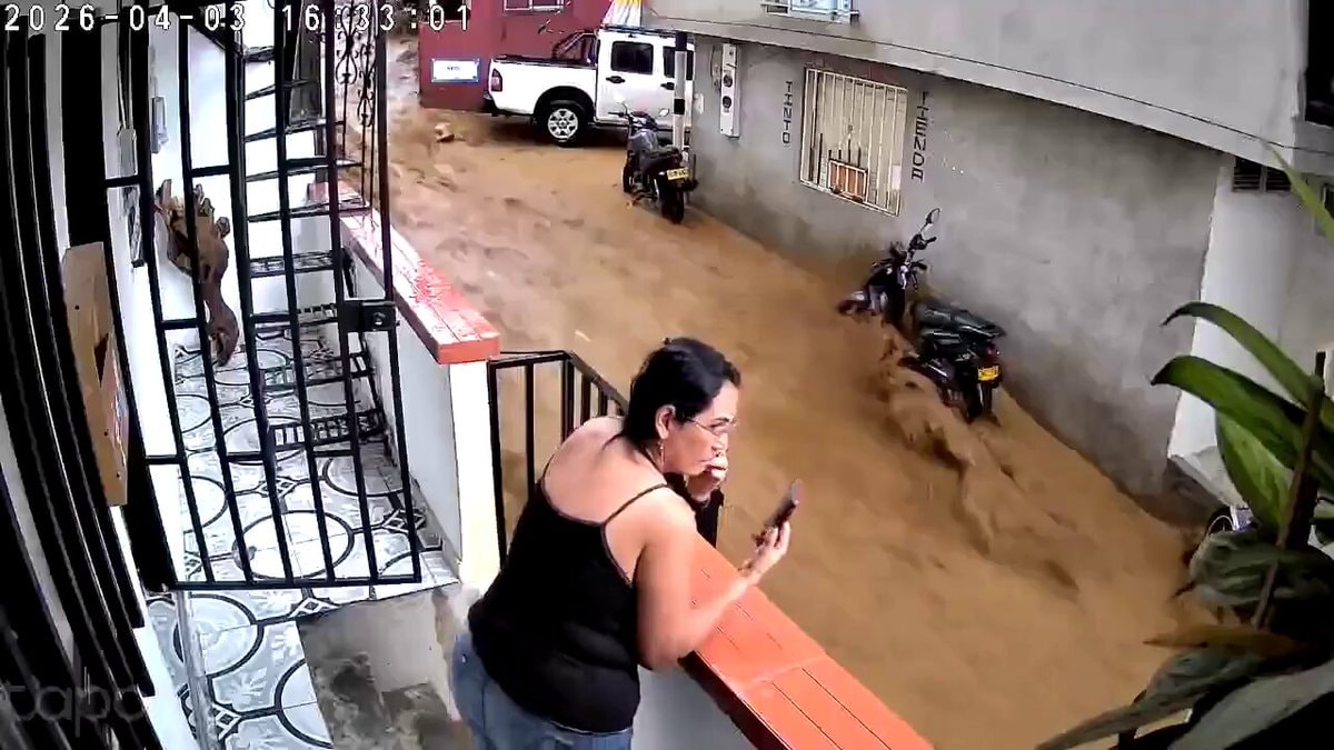 woman on balcony with phone