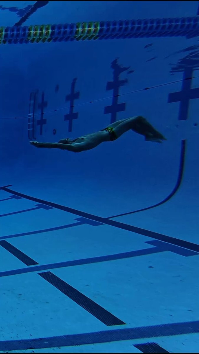 backstroke swimmer underwater in pool
