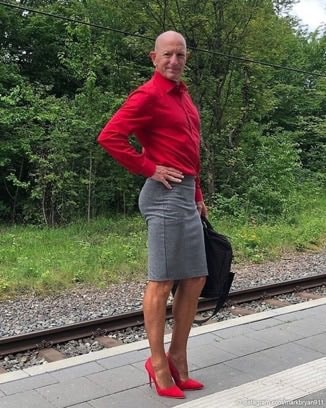 man in skirt and heels on train platform (photo 2 of 2)
