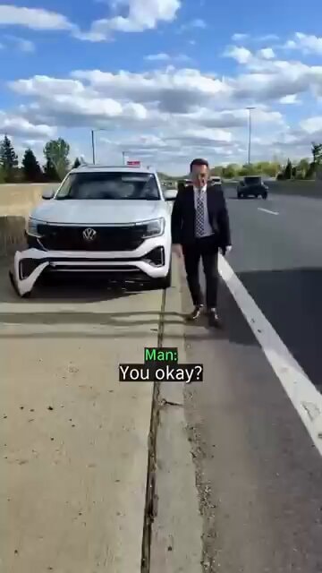 Suited man on highway shoulder