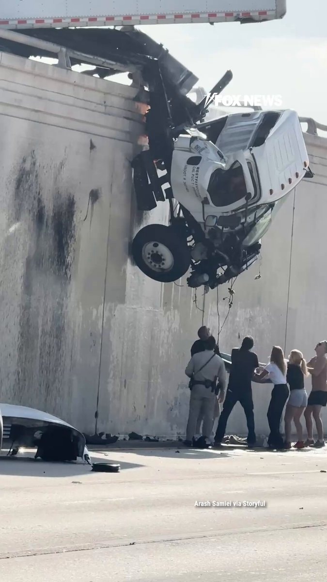 Semi truck dangles over I-5 in San Diego