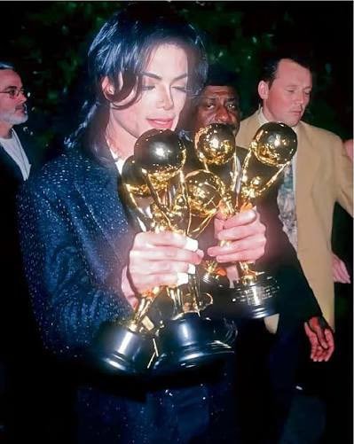 Man Holding Awards (photo 3 of 4)