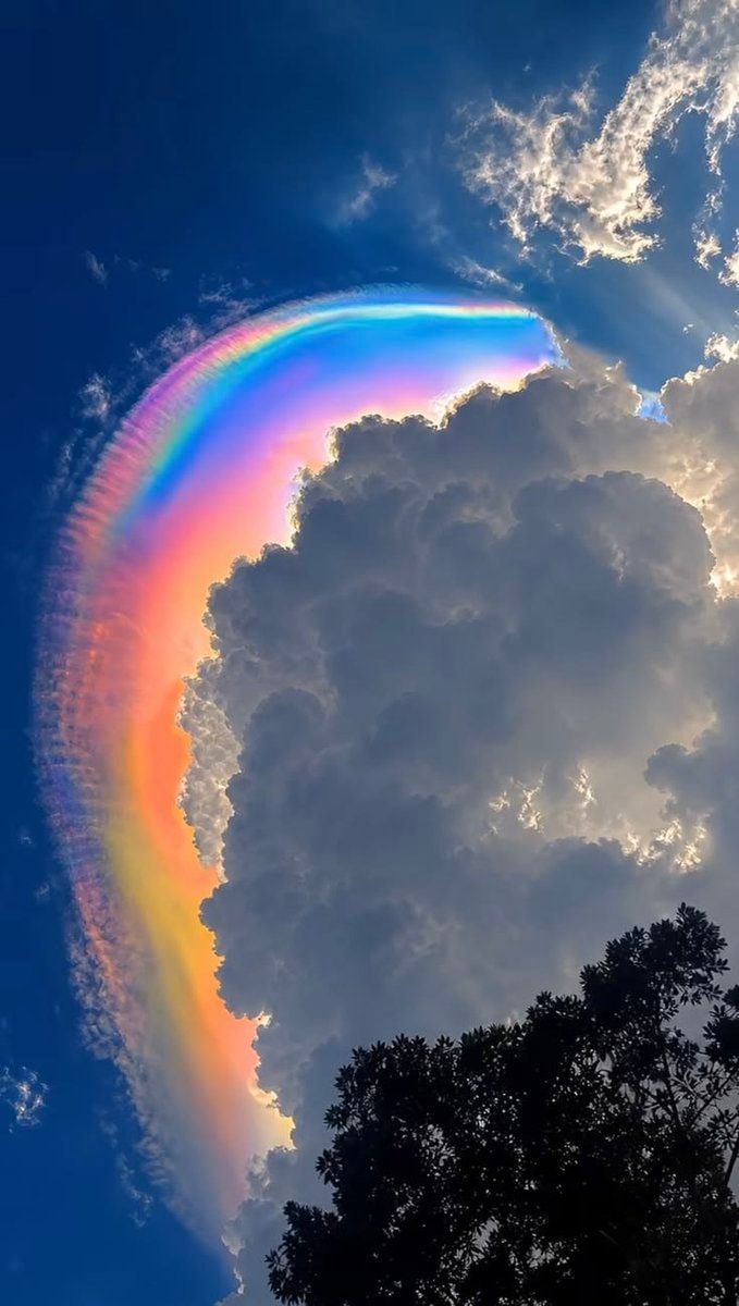 rainbow clouds against blue sky (photo 4 of 4)
