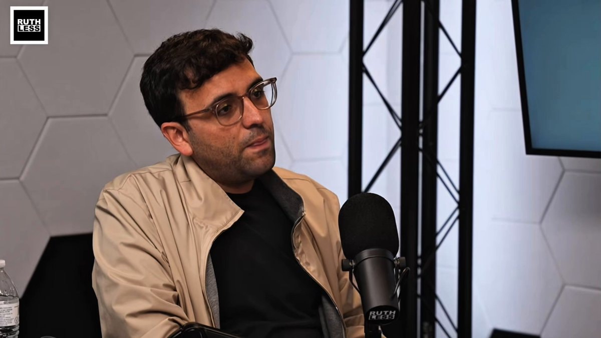 Man with glasses at microphone